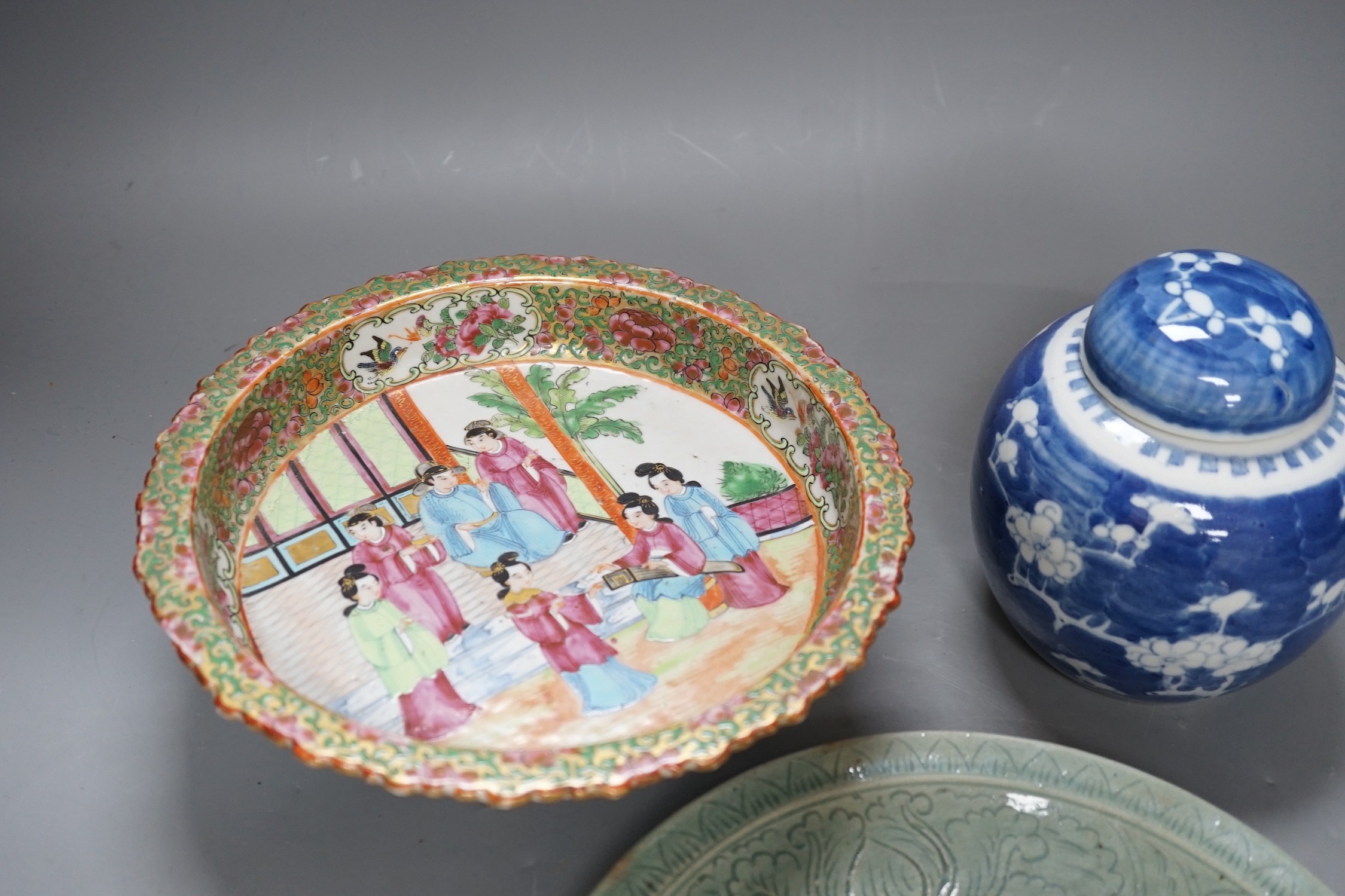 A Chinese famille rose pedestal dish, 23cm, a Thai celadon dish and a blue and white prunus jar and cover.